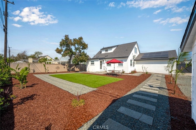 6082 Bannock Rd, Westminster, CA 92683 - rear view of house with solar panels, a patio area, and stucco siding