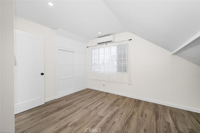 6082 Bannock Rd, Westminster, CA 92683 - bonus room with a wall mounted AC, wood finished floors, vaulted ceiling, baseboards, and recessed lighting