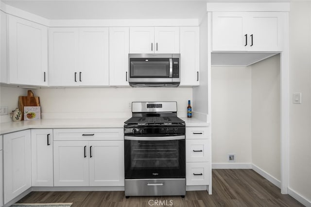 6082 Bannock Rd, Westminster, CA 92683 - kitchen with stainless steel appliances, dark wood finished floors, baseboards, and white cabinets