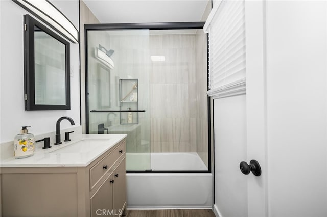 6082 Bannock Rd, Westminster, CA 92683 - full bathroom featuring vanity, bath / shower combo with glass door, and wood finished floors