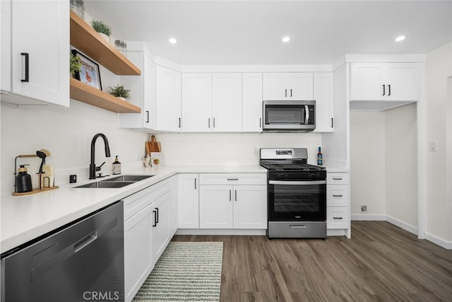 6082 Bannock Rd, Westminster, CA 92683 - kitchen featuring appliances with stainless steel finishes, a sink, dark wood finished floors, open shelves, and white cabinetry