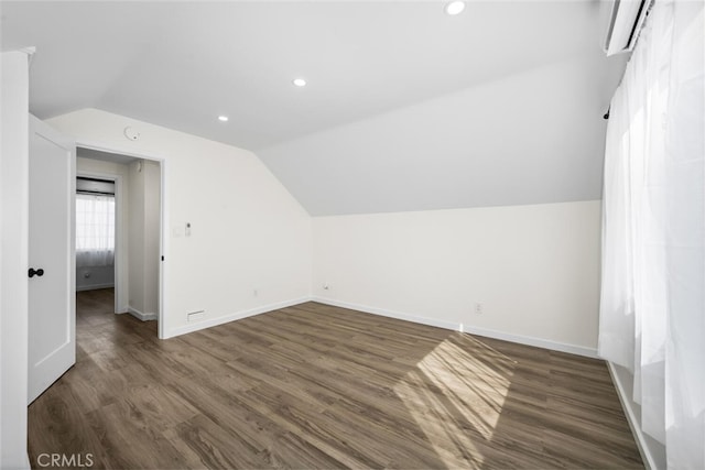 6082 Bannock Rd, Westminster, CA 92683 - bonus room featuring lofted ceiling, baseboards, dark wood-style flooring, recessed lighting, and an AC wall unit