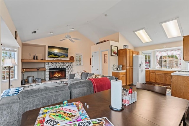 1285 Yukon Dr, Lake Arrowhead, CA 92352 - dining area featuring lofted ceiling, a ceiling fan, and a fireplace