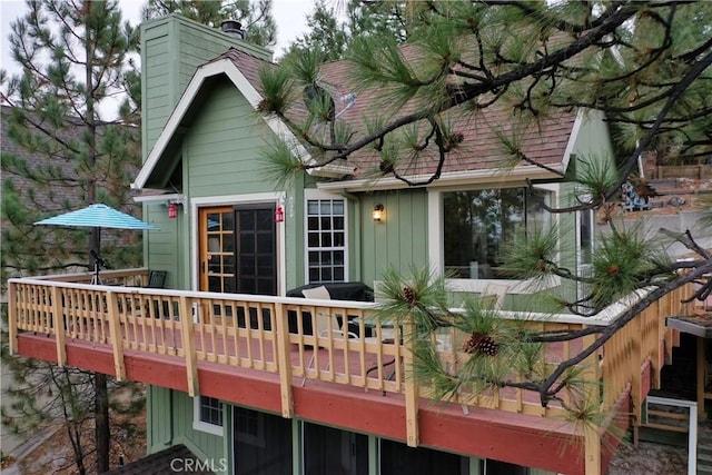 1285 Yukon Dr, Lake Arrowhead, CA 92352 - rear view of property with a chimney and a wooden deck