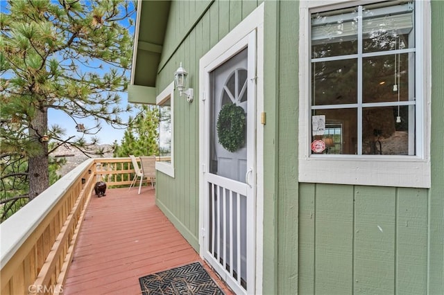 1285 Yukon Dr, Lake Arrowhead, CA 92352 - view of exterior entry featuring a wooden deck and board and batten siding