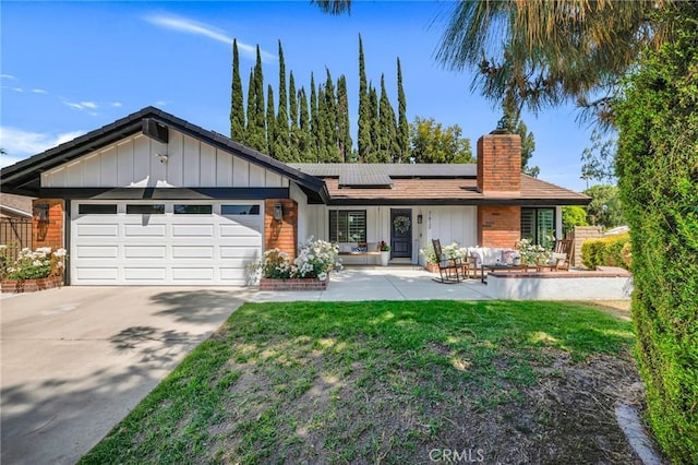 7612 Vicky Ave, West Hills, CA 91304 - mid-century inspired home with an outdoor hangout area, a chimney, a garage, solar panels, and driveway