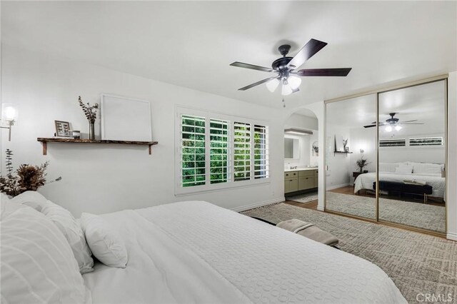 7612 Vicky Ave, West Hills, CA 91304 - bedroom with a ceiling fan, a closet, arched walkways, and wood finished floors
