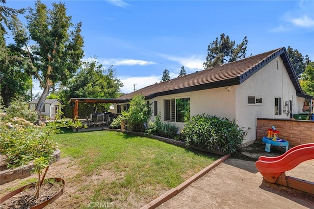 7612 Vicky Ave, West Hills, CA 91304 - back of house with a patio, stucco siding, and a lawn