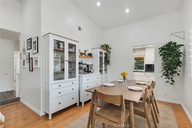 7612 Vicky Ave, West Hills, CA 91304 - dining area with high vaulted ceiling, light wood-style flooring, baseboards, and recessed lighting