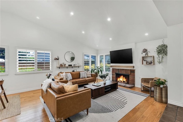 7612 Vicky Ave, West Hills, CA 91304 - living area with lofted ceiling, a fireplace, recessed lighting, wood finished floors, and baseboards