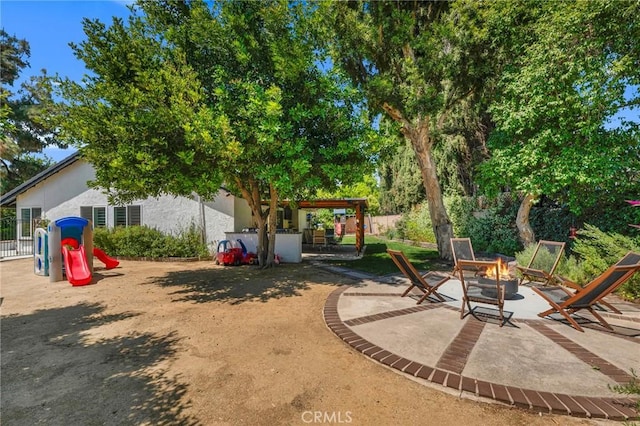 7612 Vicky Ave, West Hills, CA 91304 - view of yard featuring an outdoor fire pit and a patio