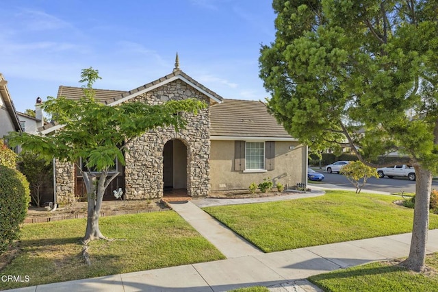 3806 Golden Pond Dr, Camarillo, CA 93012 - view of front facade featuring stucco siding, a tiled roof, a front lawn, and stone siding