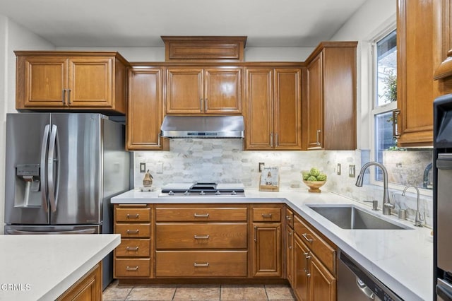 3806 Golden Pond Dr, Camarillo, CA 93012 - kitchen featuring stainless steel appliances, under cabinet range hood, a sink, light countertops, and brown cabinets