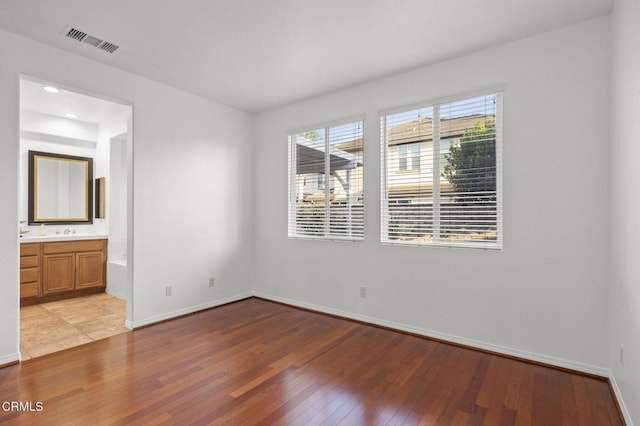 3806 Golden Pond Dr, Camarillo, CA 93012 - unfurnished bedroom featuring wood-type flooring, baseboards, and connected bathroom