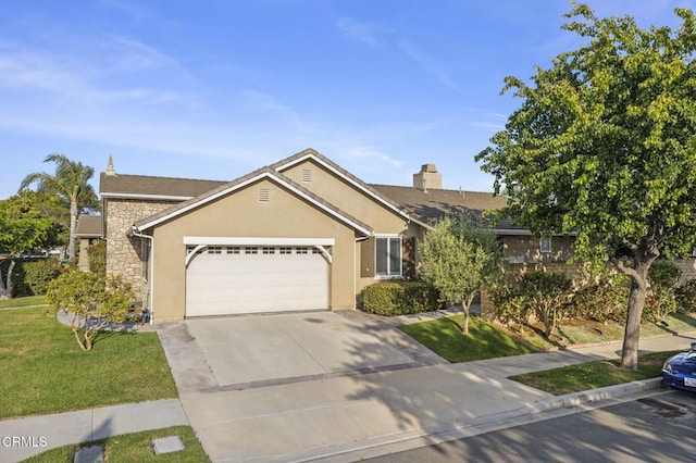 3806 Golden Pond Dr, Camarillo, CA 93012 - view of front of house featuring stone siding, an attached garage, driveway, a front lawn, and stucco siding