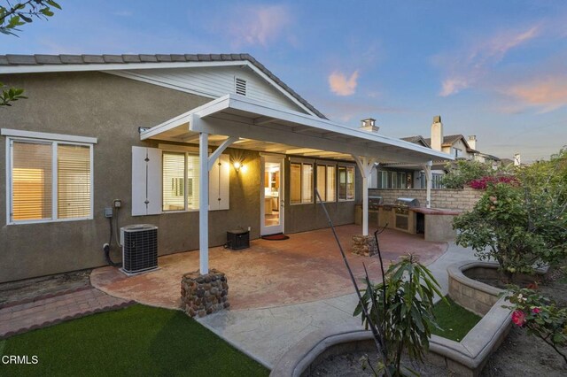 3806 Golden Pond Dr, Camarillo, CA 93012 - back of property at dusk with area for grilling, central AC unit, a patio, and stucco siding