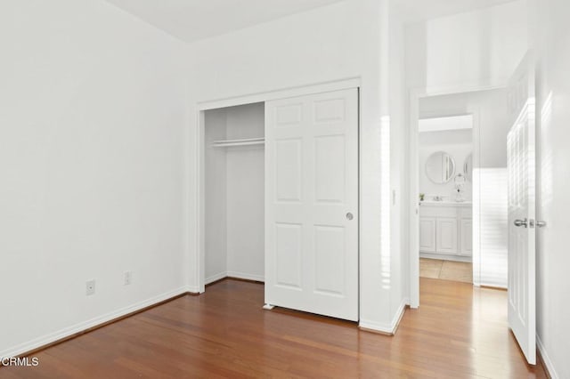 3806 Golden Pond Dr, Camarillo, CA 93012 - unfurnished bedroom with wood finished floors, a closet, and baseboards