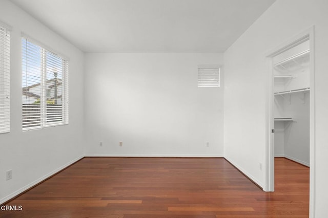3806 Golden Pond Dr, Camarillo, CA 93012 - unfurnished bedroom with a spacious closet, wood finished floors, baseboards, and a closet