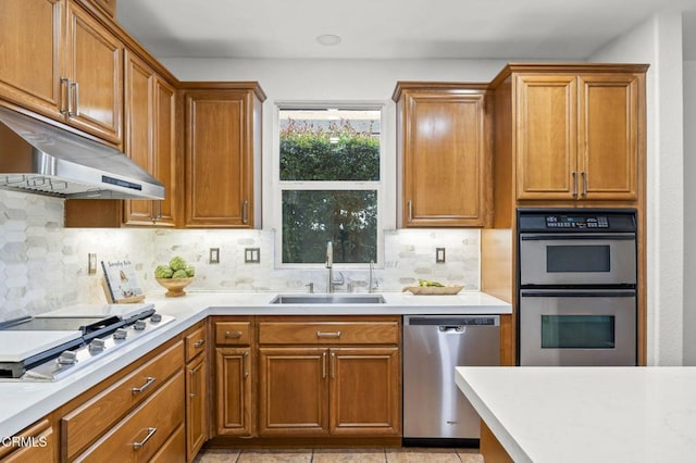 3806 Golden Pond Dr, Camarillo, CA 93012 - kitchen with stainless steel appliances, a sink, under cabinet range hood, and decorative backsplash