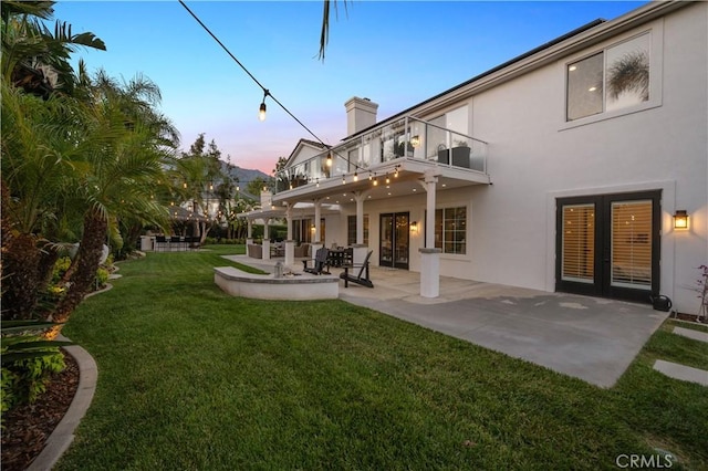 2229 N 3rd Ave, Upland, CA 91784 - back of house featuring a balcony, stucco siding, french doors, and a chimney