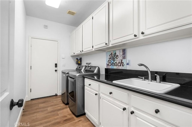 2229 N 3rd Ave, Upland, CA 91784 - laundry room with washing machine and dryer, cabinet space, and light wood-style flooring