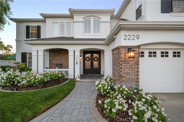 2229 N 3rd Ave, Upland, CA 91784 - entrance to property with stucco siding, brick siding, covered porch, and a garage