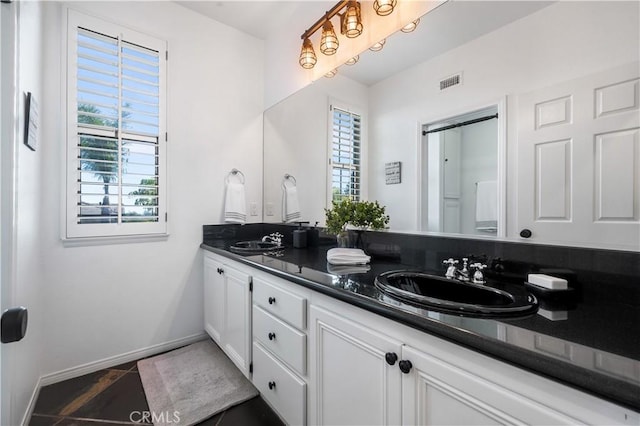 2229 N 3rd Ave, Upland, CA 91784 - bathroom featuring double vanity, plenty of natural light, baseboards, and tile patterned flooring