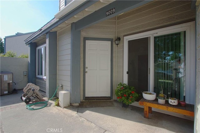 9009 Buckles St, Downey, CA 90241 - property entrance with central AC and a patio area