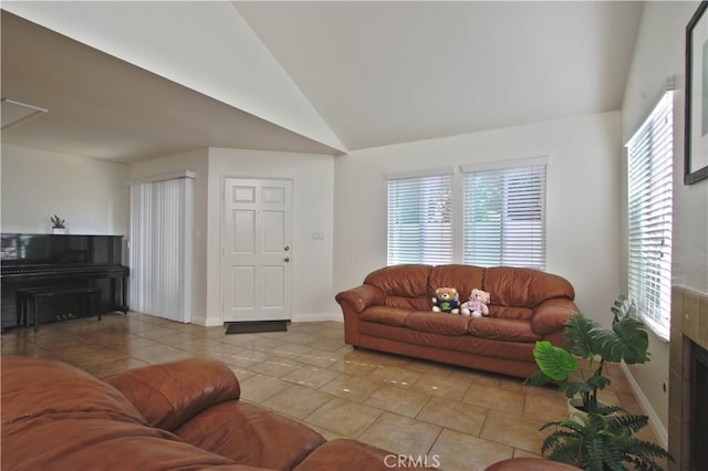 9009 Buckles St, Downey, CA 90241 - tiled living area featuring vaulted ceiling and baseboards