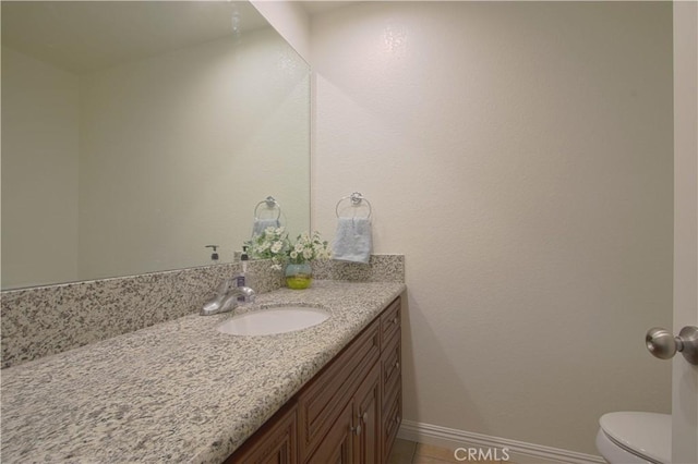 9009 Buckles St, Downey, CA 90241 - bathroom with vanity, toilet, baseboards, and tile patterned floors