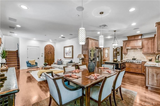 638 Sierra Madre Blvd Unit D, Sierra Madre, CA 91024 - dining area featuring light wood-type flooring, recessed lighting, stairs, arched walkways, and baseboards