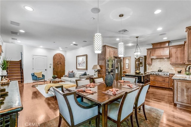 638 Sierra Madre Blvd Unit D, Sierra Madre, CA 91024 - dining space with light wood-style floors, recessed lighting, stairs, and arched walkways