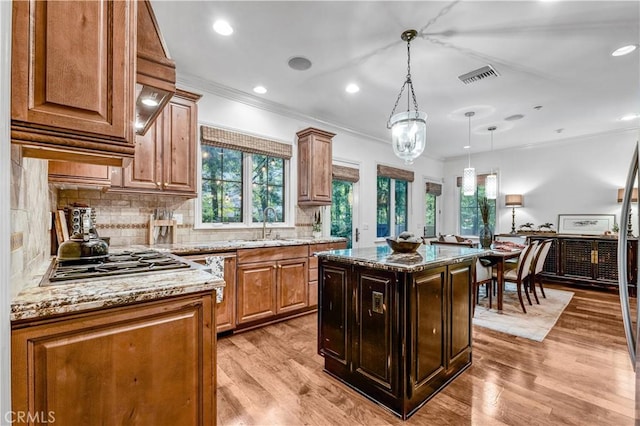 638 Sierra Madre Blvd Unit D, Sierra Madre, CA 91024 - kitchen featuring stainless steel gas cooktop, ornamental molding, light stone counters, tasteful backsplash, and light wood-style flooring