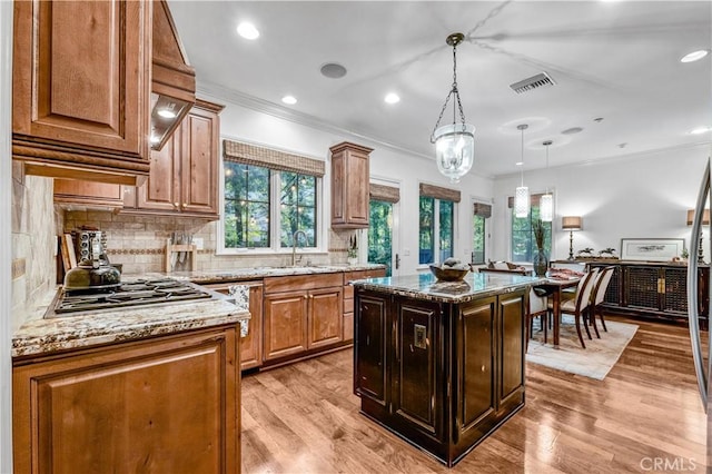 638 Sierra Madre Blvd Unit D, Sierra Madre, CA 91024 - kitchen with stainless steel gas cooktop, crown molding, light stone countertops, plenty of natural light, and decorative backsplash