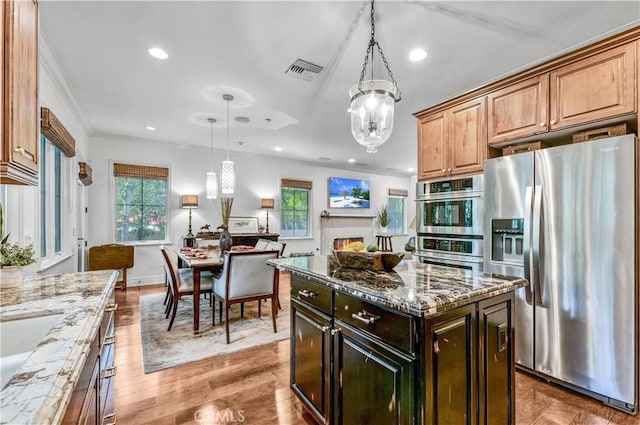 638 Sierra Madre Blvd Unit D, Sierra Madre, CA 91024 - kitchen with appliances with stainless steel finishes, a chandelier, recessed lighting, light stone countertops, and crown molding