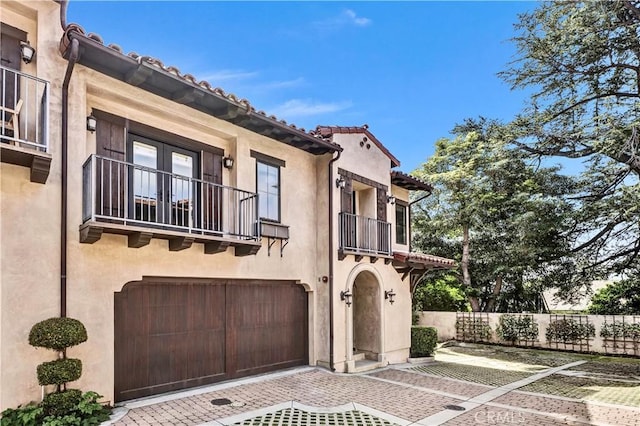 638 Sierra Madre Blvd Unit D, Sierra Madre, CA 91024 - view of front of home with a balcony, stucco siding, an attached garage, and decorative driveway