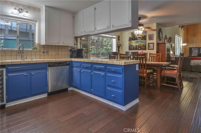 1353 Golden Rule Ln, Lake Arrowhead, CA 92352 - kitchen with dishwasher, blue cabinetry, dark wood-style floors, a peninsula, and a sink