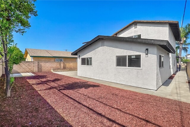 623 S Homerest Ave, Azusa, CA 91702 - rear view of house with a fenced backyard, stucco siding, and a patio