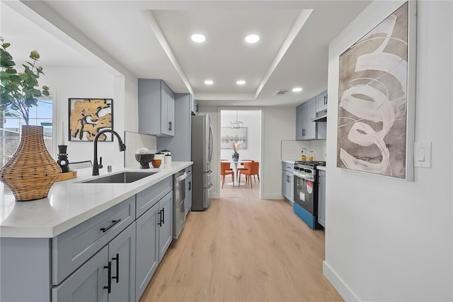 623 S Homerest Ave, Azusa, CA 91702 - kitchen with gray cabinetry, a sink, stainless steel appliances, light wood-style flooring, and recessed lighting