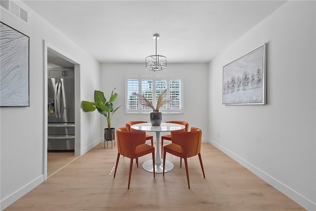 623 S Homerest Ave, Azusa, CA 91702 - dining area with a chandelier, light wood-style flooring, and baseboards