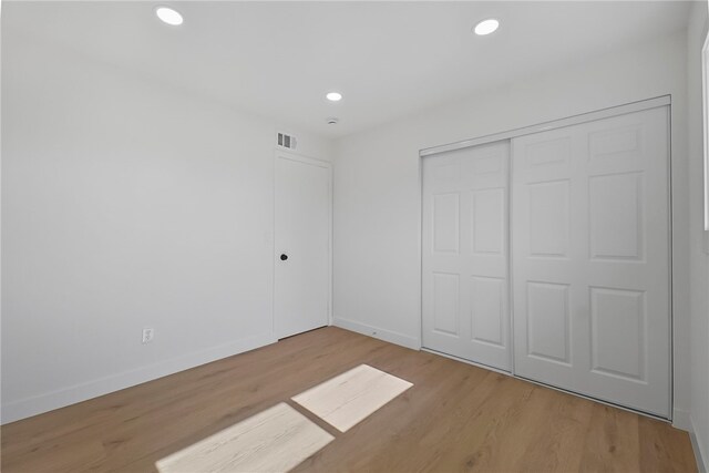 623 S Homerest Ave, Azusa, CA 91702 - unfurnished bedroom featuring wood finished floors, baseboards, recessed lighting, and a closet