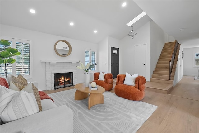 623 S Homerest Ave, Azusa, CA 91702 - living room featuring lofted ceiling, a brick fireplace, healthy amount of natural light, recessed lighting, and stairs