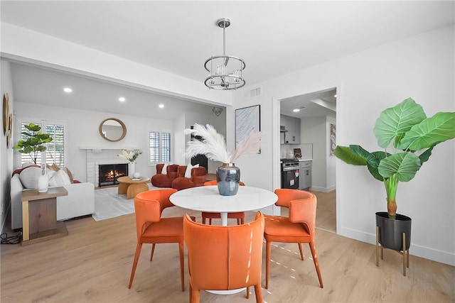 623 S Homerest Ave, Azusa, CA 91702 - dining room with a chandelier, light wood-style flooring, a brick fireplace, baseboards, and recessed lighting
