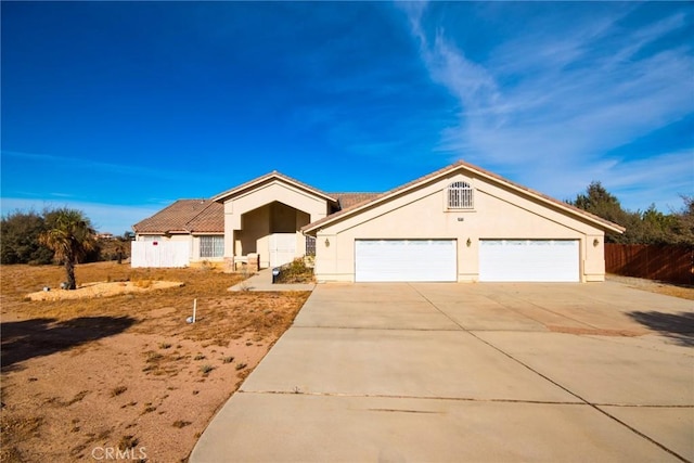 9920 Sage St, Oak Hills, CA 92344 - ranch-style house featuring driveway, stucco siding, and an attached garage