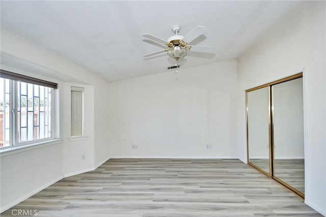 9920 Sage St, Oak Hills, CA 92344 - unfurnished bedroom with wood finished floors, a closet, lofted ceiling, a ceiling fan, and baseboards