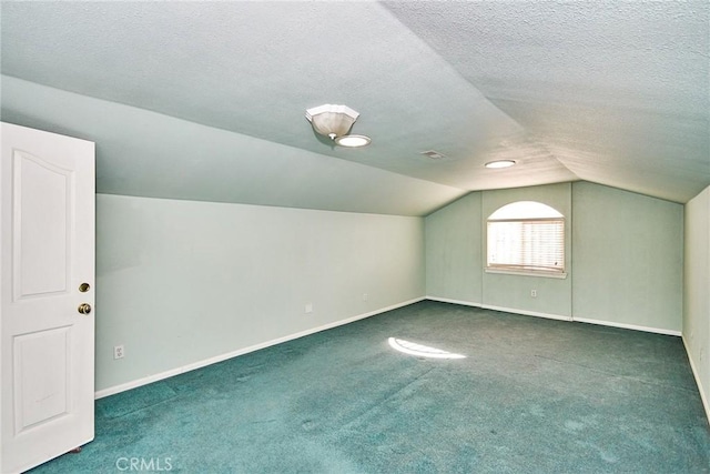 9920 Sage St, Oak Hills, CA 92344 - additional living space featuring lofted ceiling, carpet floors, a textured ceiling, and baseboards