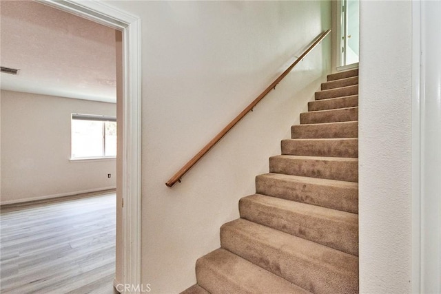 9920 Sage St, Oak Hills, CA 92344 - stairs with wood finished floors and baseboards