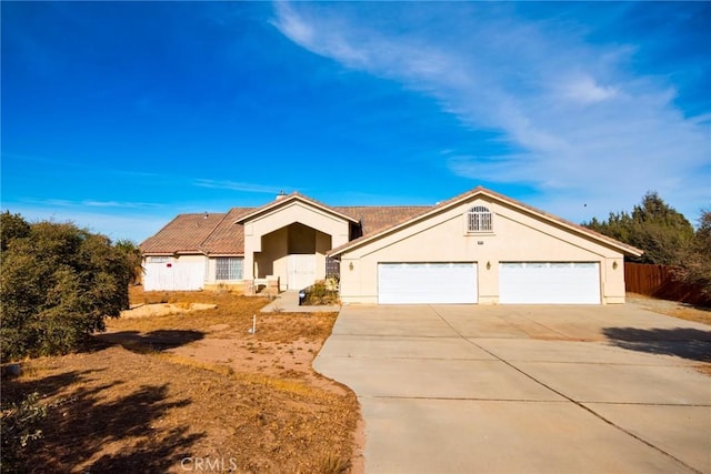 9920 Sage St, Oak Hills, CA 92344 - single story home with stucco siding, driveway, and a garage