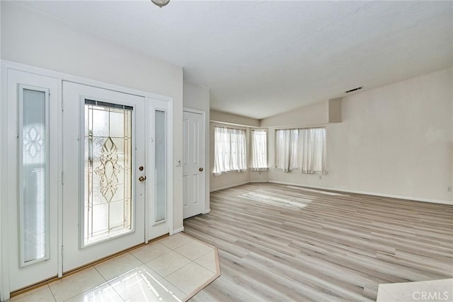 9920 Sage St, Oak Hills, CA 92344 - entrance foyer with lofted ceiling, light wood-style floors, and baseboards