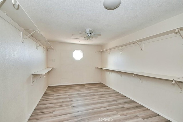9920 Sage St, Oak Hills, CA 92344 - spacious closet with wood finished floors and ceiling fan